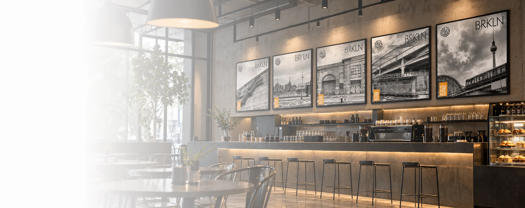 Editorial visualisation of real black-and-white artworks displayed along a contemporary cafe interior