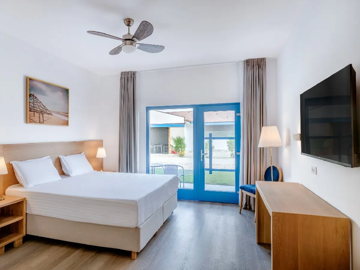 Framed coastal artwork installed in a guestroom at Gura Portitei Hotel.