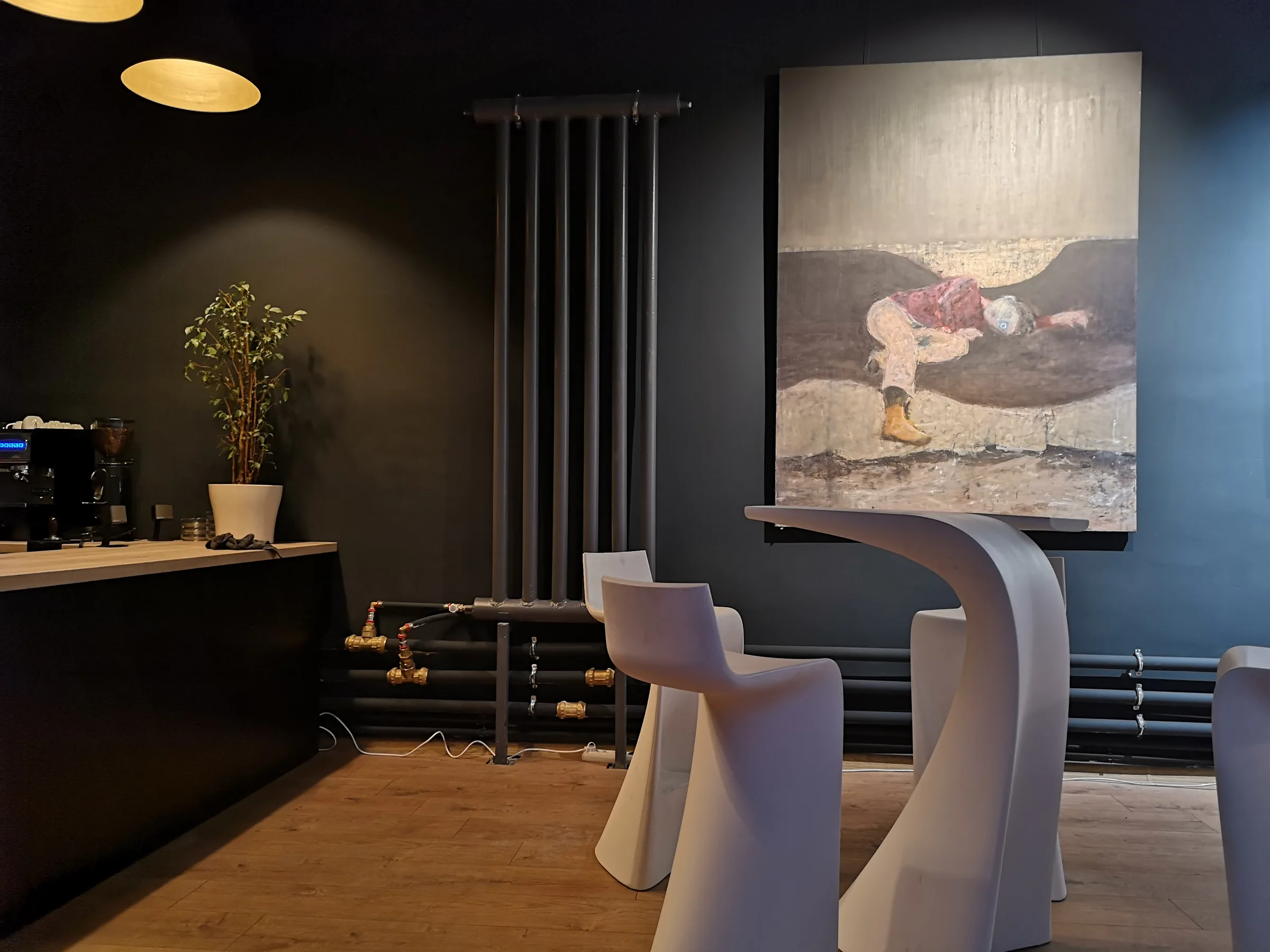 Large purple figurative painting displayed behind the timber bistro counter.