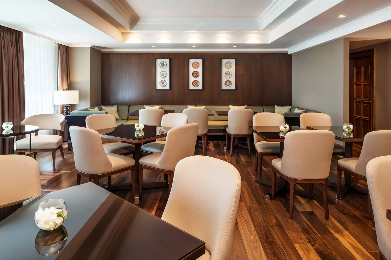 Framed ceramic compositions continuing through a shared lounge at JW Marriott Bucharest Grand Hotel.