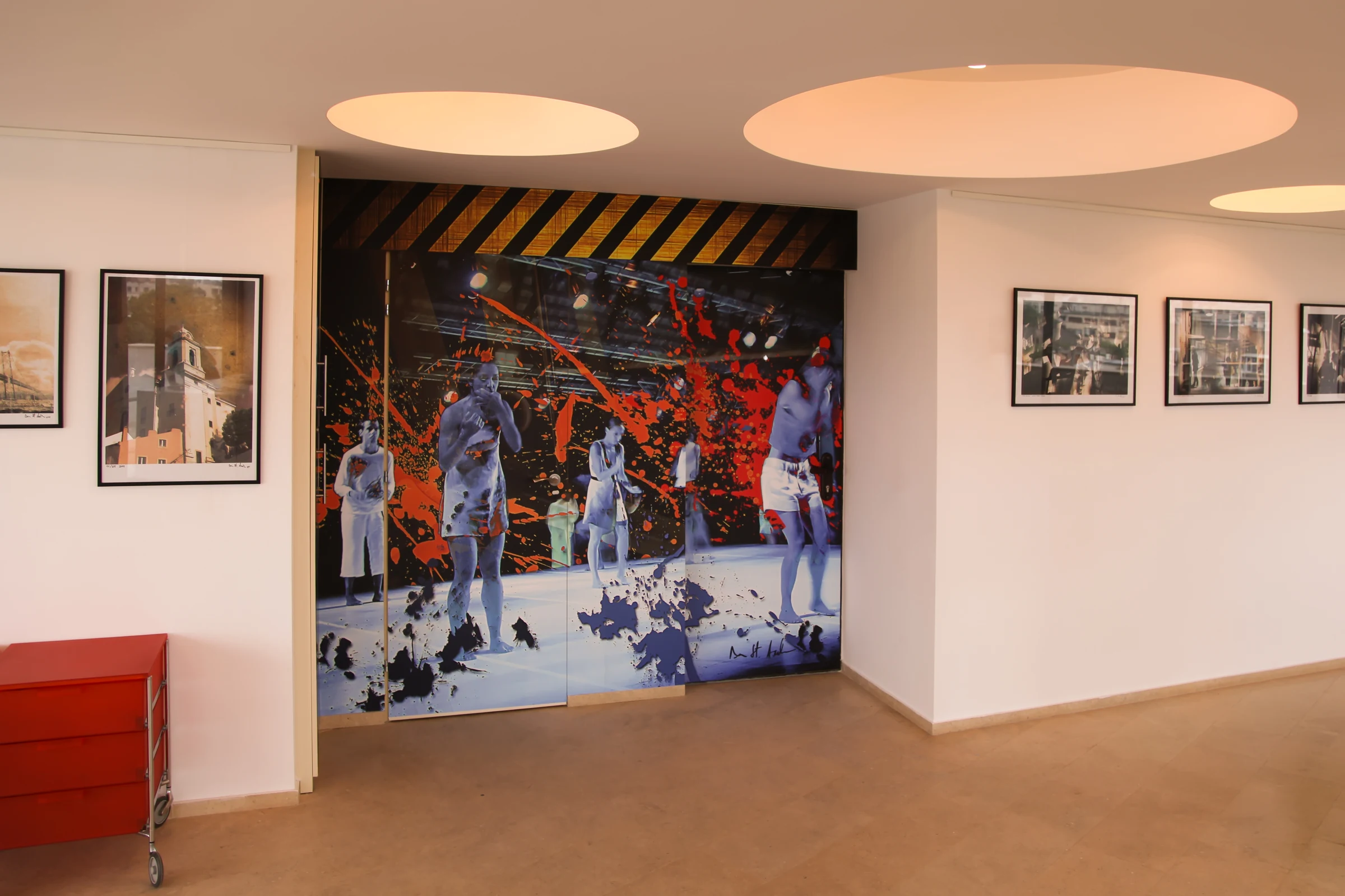 A wall-scale print after a graphic work by Dan Andrei anchors the Penthouse Gallery event space.