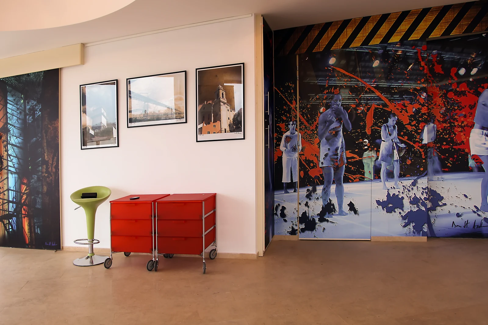 Wall-scale graphic work and framed photography operating together within the event environment.